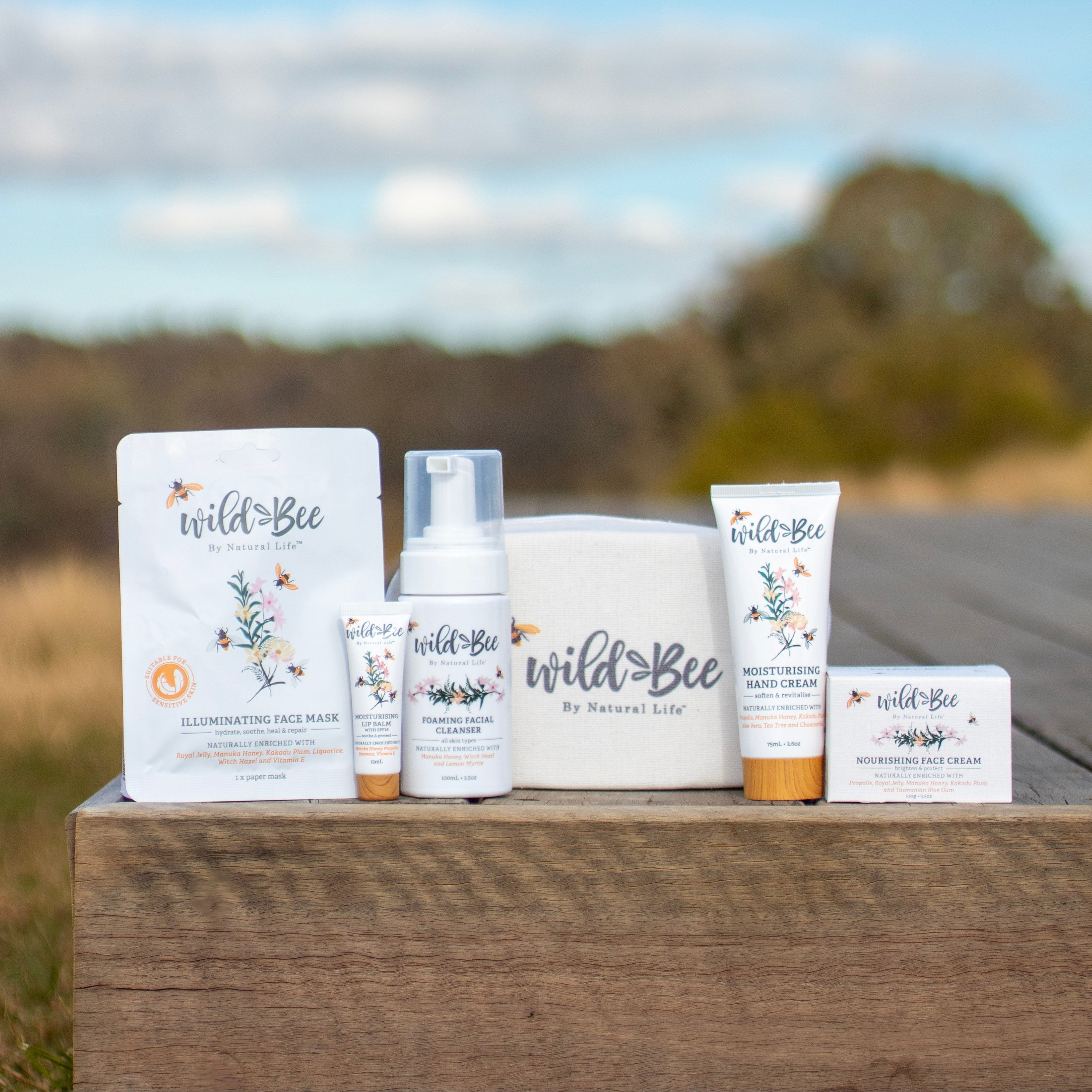 Wild Bee skincare essentials pack on a wooden surface with a natural background