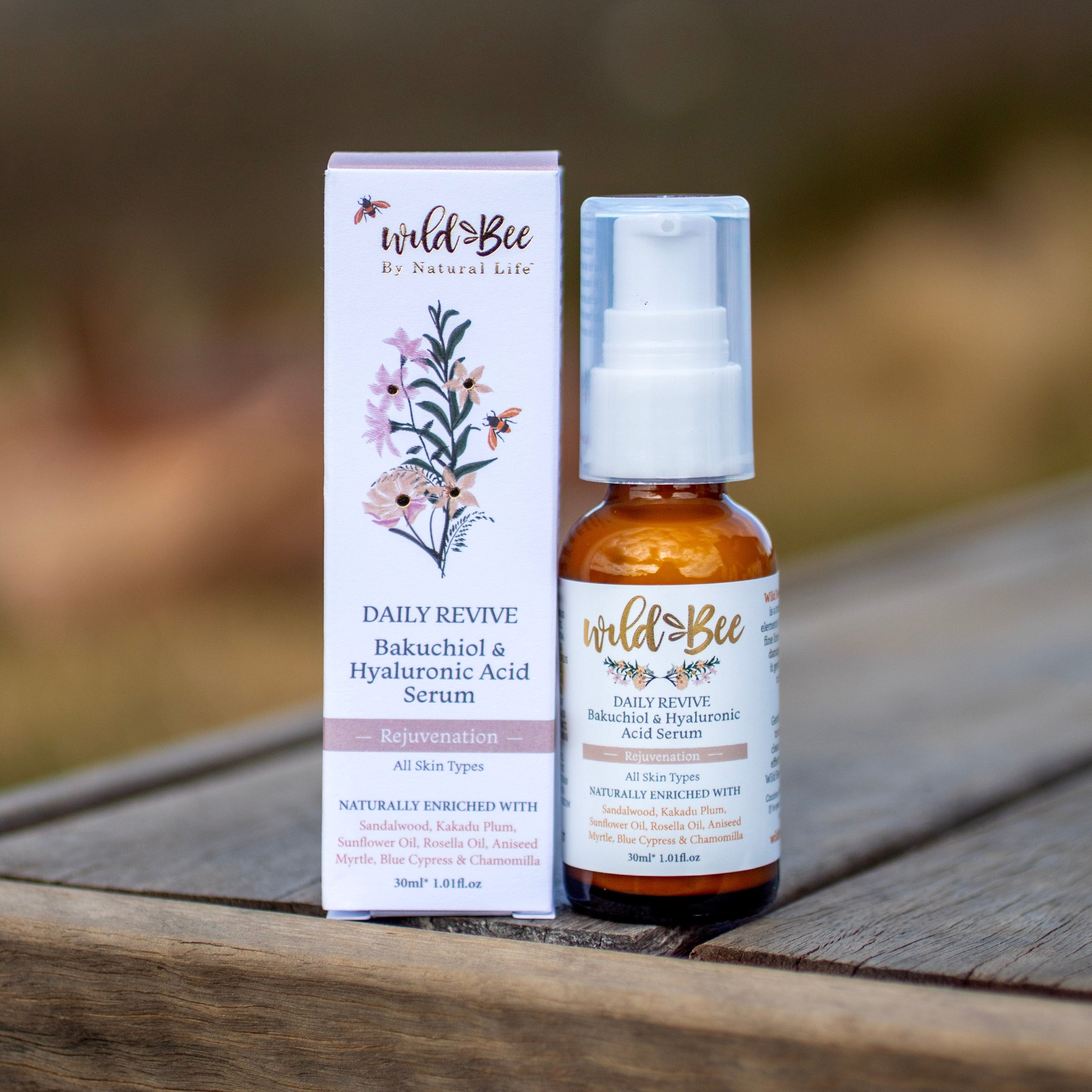 Wild Bee Daily Revive packaging on a wooden surface with a blurred natural background